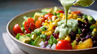 A Colorful Salad In A Bowl Topped With Dressing And Garnished With Fresh Vegetables — Stock Photo