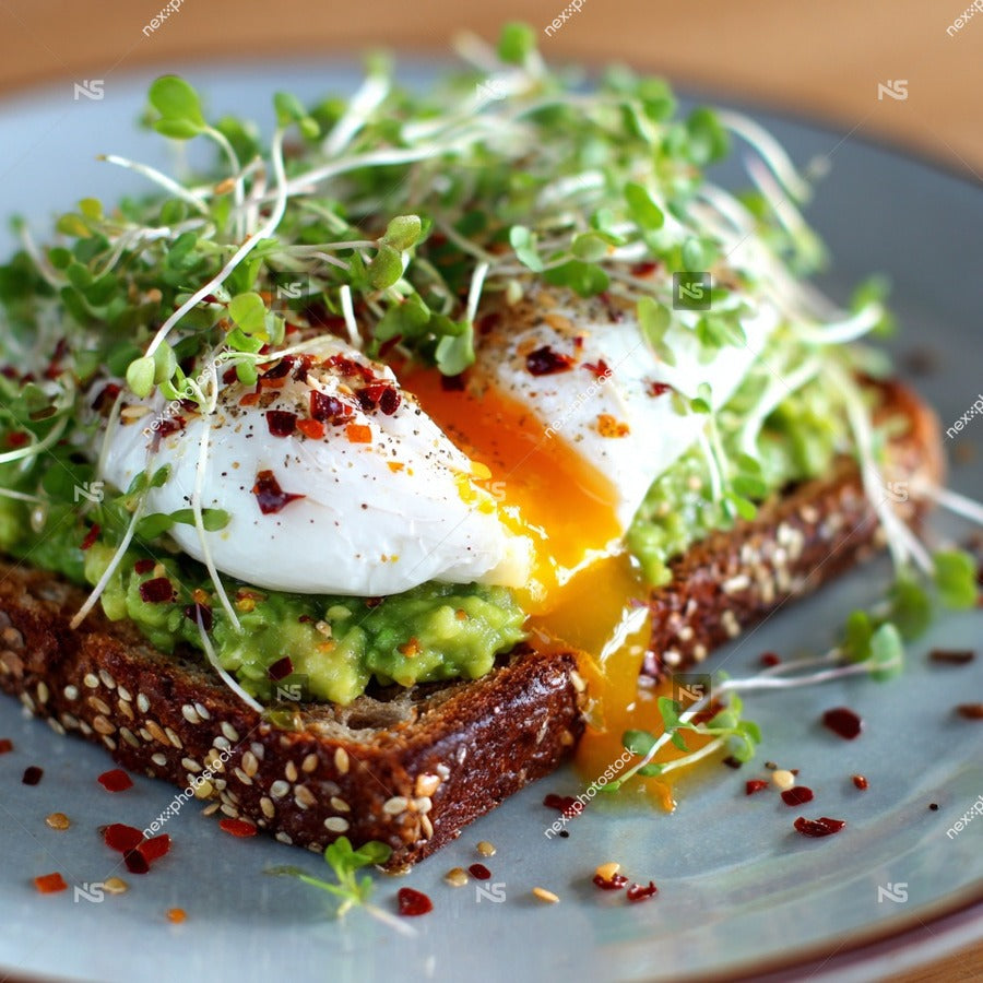 A Plate Of Avocado Toast Topped With A Fried Egg Garnished With Microgreens And Red Pepper Flakes 2 — Stock Photo
