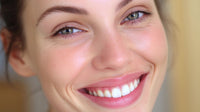 a woman with blue eyes is captured in a close up portrait smiling at the camera - Stock Video