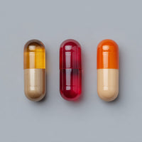 Four Pills Each A Different Color Displayed In A Row Against A Neutral Background — Stock Photo