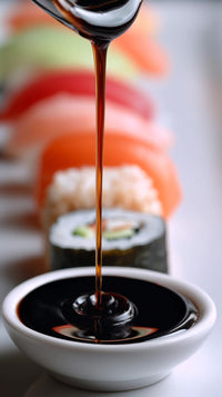 a close up image of a sushi roll and dipping sauce showcasing the process of dipping the sushi in the sauce - Stock Video