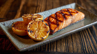 Grilled Salmon With Glaze On A Plate Served Alongside Sliced Oranges And Garnished With Grilled Pineapple — Stock Photo