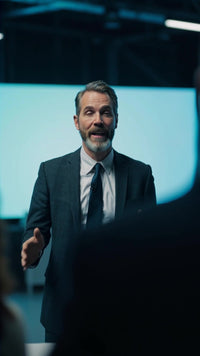 man in suit giving speech at event - Stock Video