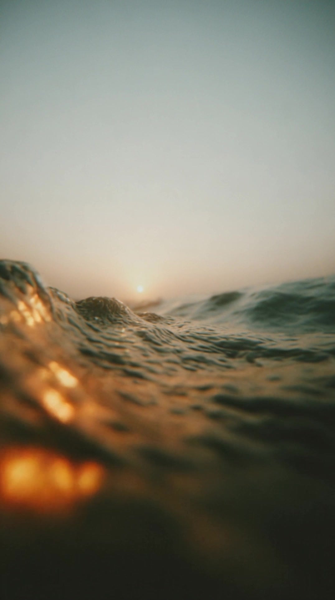 captures a serene sunset scene over the ocean with the horizon line visible in the background - Stock Video