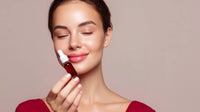 a woman holding a bottle of perfume in front of her face - Stock Video