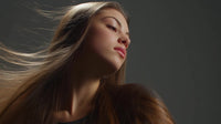 a woman with long hair captured in motion showcasing a dynamic portrait against a dark background - Stock Video