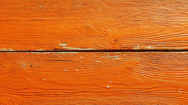 Red Wooden Plank With Visible Grain And Texture Set Against A Solid Background — Stock Photo