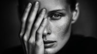 A Black And White Portrait Of A Woman With Her Hand Placed Over Her Face — Stock Photo