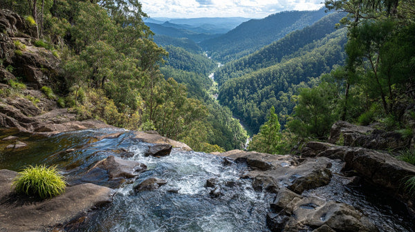 Aerial View Of A Mountainous Landscape With Lush Greenery A Winding River And A Clear Blue Sky — Stock Photo