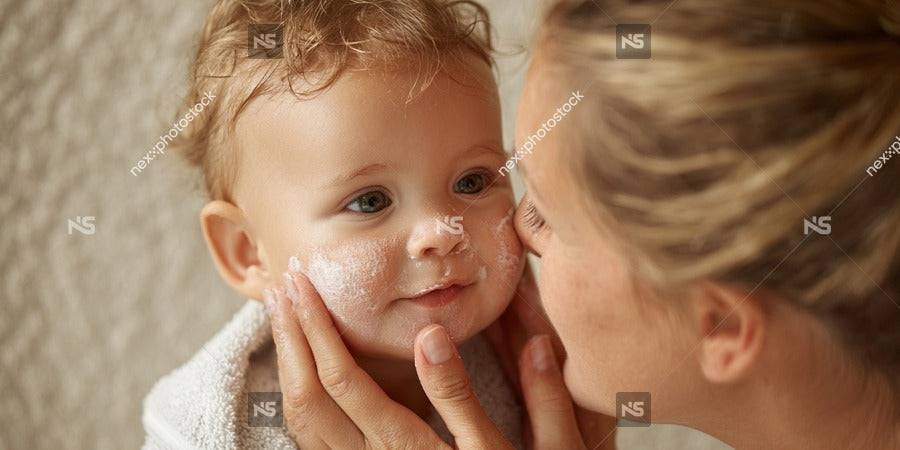 A Woman Lovingly Applying A Cream Lotion To A Baby S Face Capturing An Intimate Moment Between Them — Stock Photo