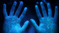 Human Hands With Blue Handprints From A Paint Dye Application Against A Dark Background — Stock Photo