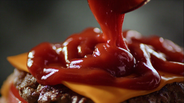 Ketchup Splatters On A Cheeseburger — Stock Photo
