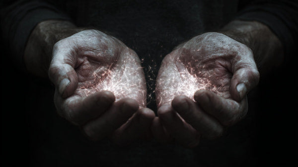 A Pair Of Hands Gently Cradling A Small Amount Of Ash Set Against A Dark Background — Stock Photo