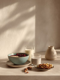A Bowl Of Nuts Sits On A Table Accompanied By A Glass Jar And A Vase — Stock Photo