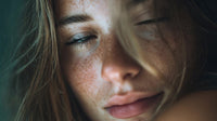 a close up portrait of a woman with freckles captured in a soft focused shot against a blue background - Stock Video