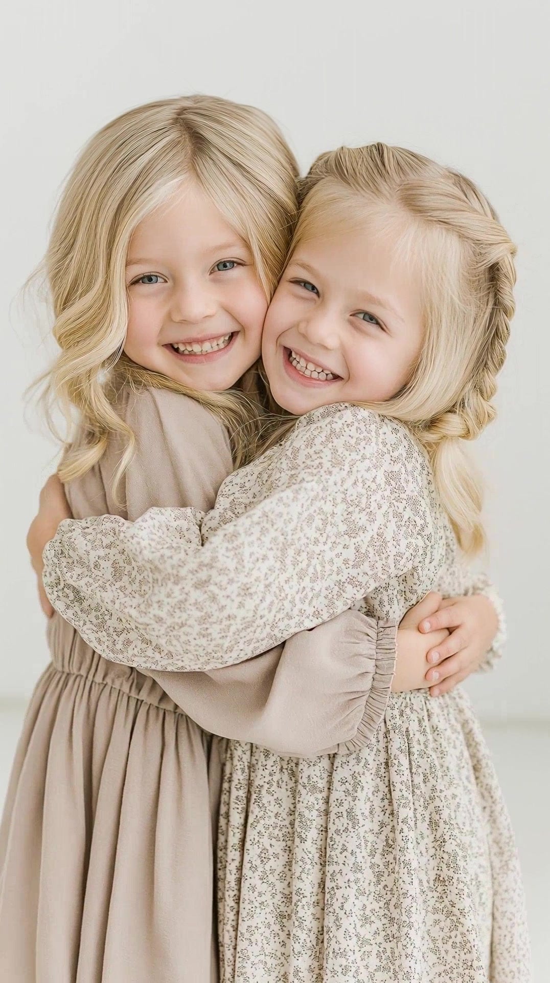 two young girls hugging in a studio setting - Stock Video