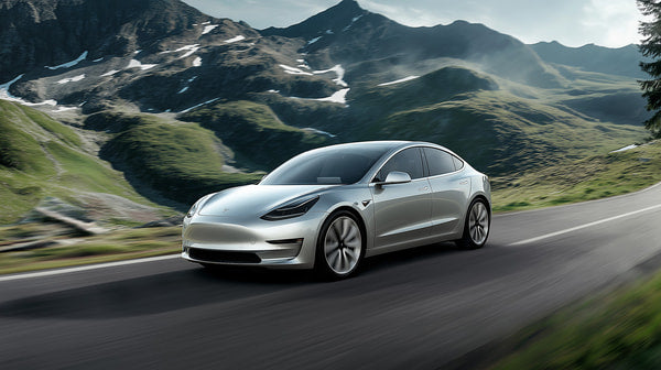A Promotional Photograph A Silver Tesla Electric Car In Motion On A Winding Road With Mountainous Terrain In The Background — Stock Photo