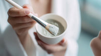 a person s hand mixing a creamy substance in a bowl with a spoon visible - Stock Video
