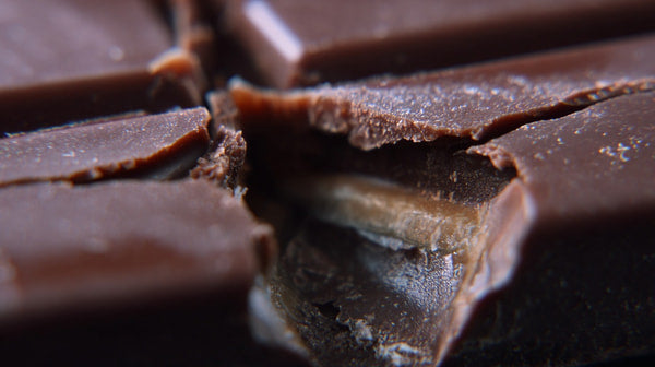 A Close Up Photograph Of A Chocolate Bar With A Broken Section Revealing Its Interior — Stock Photo