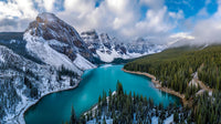 a breathtaking view of a snow covered mountain lake with a clear blue sky and majestic mountains in the background - Stock Video