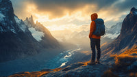 A Person Stands On A Mountain Peak Gazing Out Over A Valley With Snow Capped Mountains And A River Below — Stock Photo