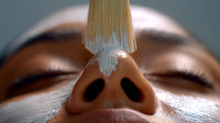 A Close Up Image Of A Person S Face Adorned With A White Face Mask With A Focus On Their Eyes And Nose — Stock Photo