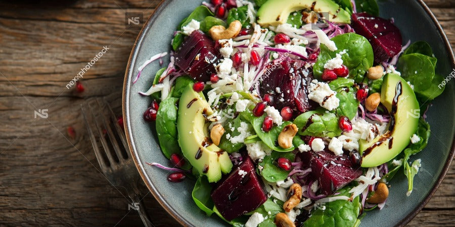 A Bowl Of Fresh Salad With Pomegranate Seeds And Crumbled Feta Cheese On A Wooden Table — Stock Photo