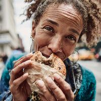 Woman Enjoying A Sandwich In An Urban Setting — Stock Photo
