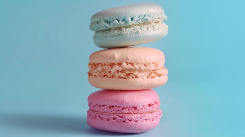 colorful macarons stacked on a blue background - Stock Video