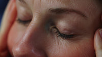 a woman with a hand on her forehead in a state of concern contemplation - Stock Video