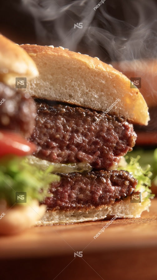 A Sesame Seed Bun With A Burger Patty Lettuce And Tomato On A Wooden Surface — Stock Photo