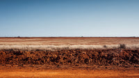 Aerial View Of A Dirt Road In The Australian Outback With Clear Blue Skies And Sparse Vegetation — Stock Photo