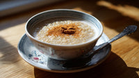 Bowl Of Oatmeal With Cinnamon On Top Served In A Blue And White Teacup Placed On A Wooden Table — Stock Photo