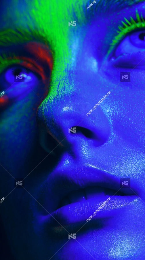 Blue Tinted Portrait Of A Person With A Neutral Expression And Blue Eyeshadow Set Against A Dark Background — Stock Photo
