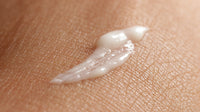 Close Up Of A Person S Skin With A Small Amount Of Cream Ointment Applied To It — Stock Photo