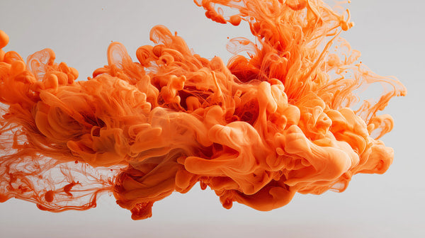 Orange Ink Splashing In Mid Air Against A White Background — Stock Photo