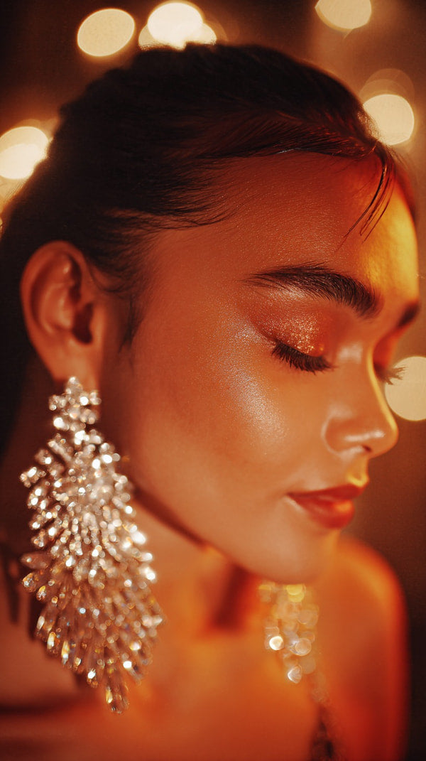 Woman Wearing Large Gold Earrings Captured From A Close Up Angle Against A Blurred Background — Stock Photo
