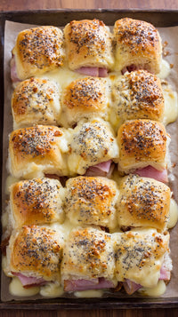 Displays A Tray Of Savory Ham And Cheese Croissants Which Are Neatly Arranged In A Grid Pattern On A Wooden Surface — Stock Photo