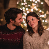 A Couple Posing For A Holiday Photo Both Wearing Festive Sweaters And Standing In Front Of A Decorated Christmas Tree — Stock Photo