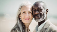 a man and a woman both middle aged share an embrace in a beach setting - Stock Video