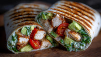 A Chicken Caesar Wrap With Tomato And Spinach Cut In Half To Reveal Its Filling Served On A Wooden Surface — Stock Photo