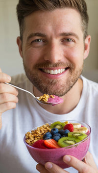 a man is holding a bowl of cereal with fruit smiling and posing for the photo - Stock Video