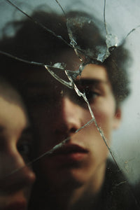 A Person S Face Is Reflected In A Shattered Glass Mirror With The Individual Looking Directly Into The Camera — Stock Photo