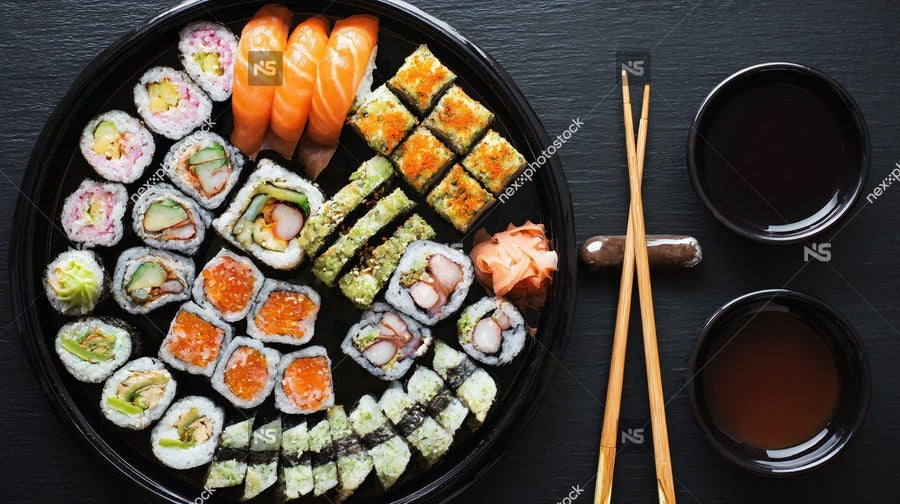 Sushi Platter With Dipping Sauces Including Sashimi And Nigiri Pieces Presented On A Black Tray With Chopsticks — Stock Photo