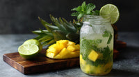 A Refreshing Mojito In A Mason Jar Garnished With Lime Wedges And Mint Leaves Sits On A Wooden Surface — Stock Photo