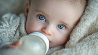 Newborn Baby With Blue Eyes Drinking From A Bottle — Stock Photo