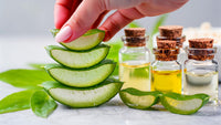 aromatherapy essential oil set on a table with sliced cucumbers and bottles of oils - Stock Video