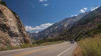 A Scenic Highway Drive Through A Mountainous Landscape With Clear Skies And A Winding Road — Stock Photo