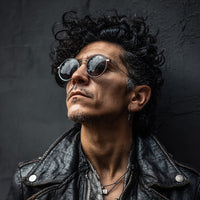 A Man In A Leather Jacket And Sunglasses Exuding A Punk Rock Vibe Stands Confidently Against A Dark Background — Stock Photo