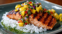 Grilled Salmon On A Bed Of Rice And Vegetables Topped With Salsa Served On A Wooden Table — Stock Photo